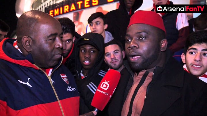 Robbie Lyle from AFTV interviews fans outside of the Emirates Stadium.