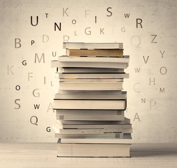 Books with flying letters on vintage old background