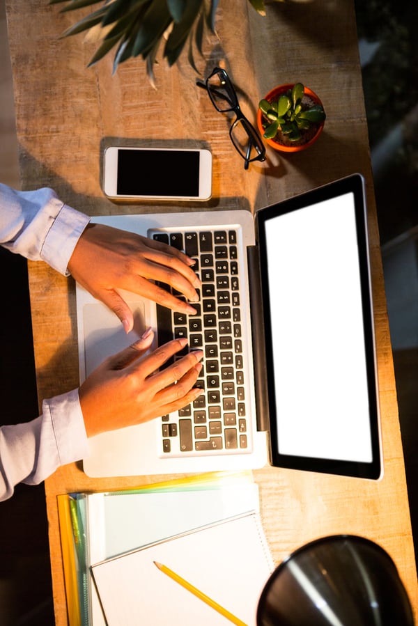 Close-up of woman working on laptop in the office