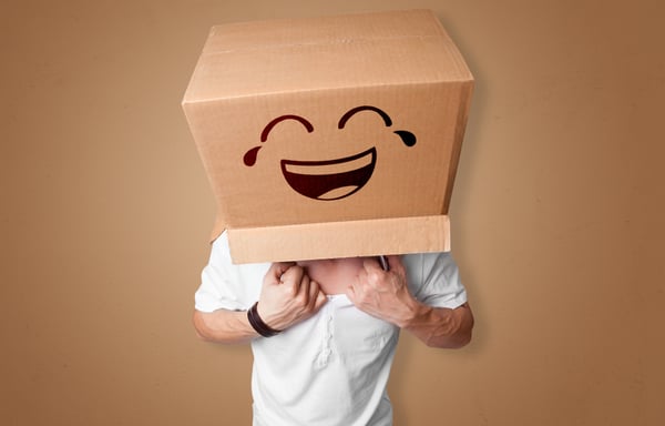 Funny man wearing cardboard box on his head with smiley face