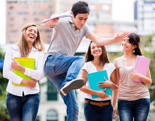 Group of students having fun looking at a man jumping