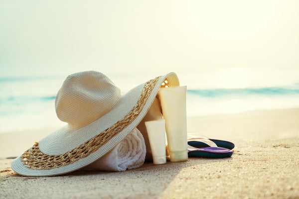 Sun lotion, hat  with bag at the tropical beach