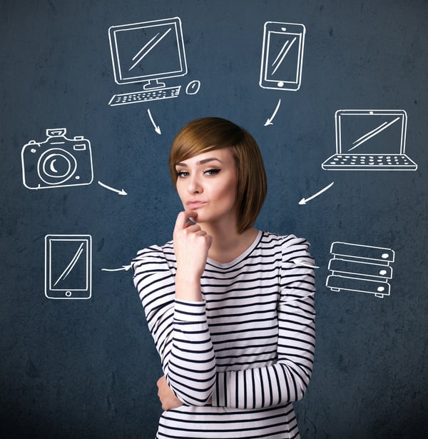 Thoughtful young woman with multimedia icons around her head