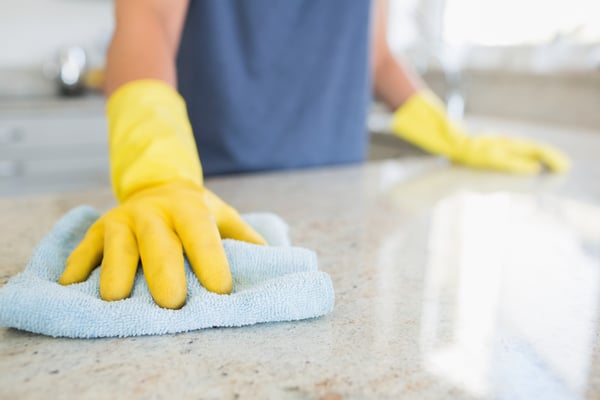 Woman cleaning the counter  in the kitchen