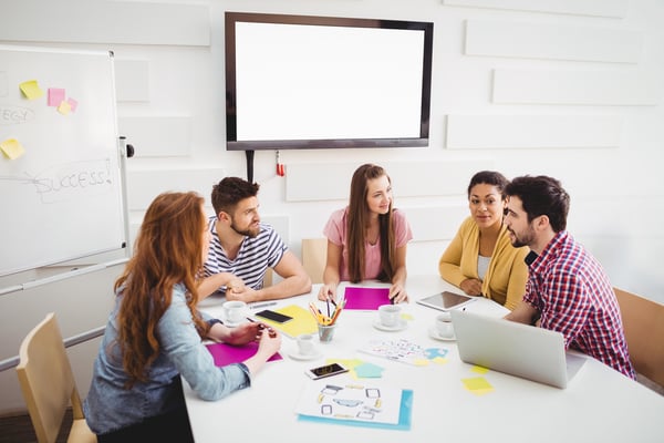 Young business people interacting in meeting at creative office