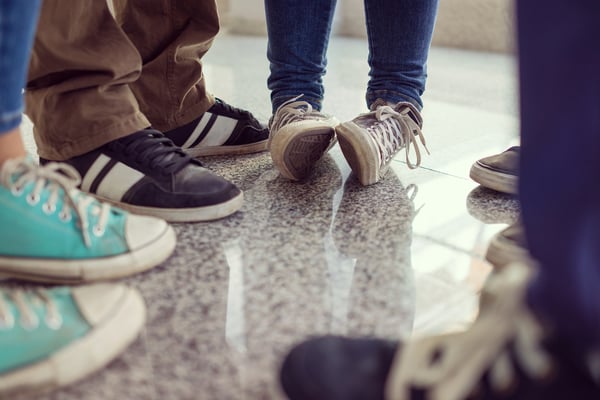 Young people legs standing in circle