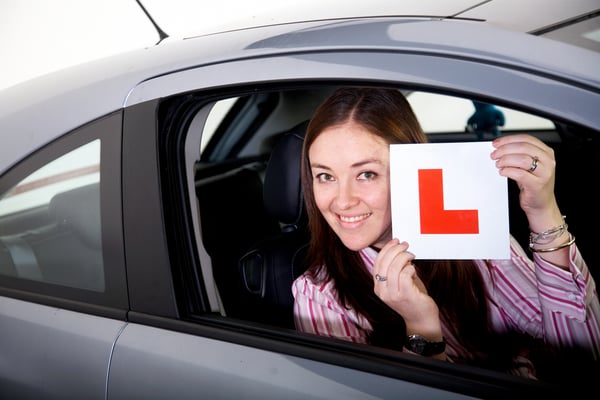 female inside a car learning to drive - studio